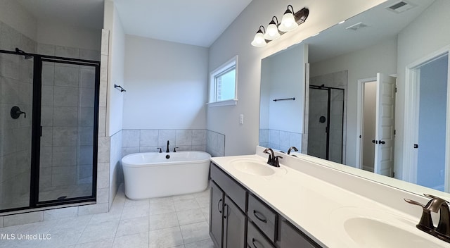 full bathroom featuring a sink, visible vents, a freestanding bath, and a stall shower