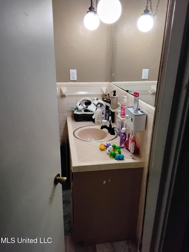 807 Line Dr, Forest, MS 39074 - bathroom with vanity, tile walls, a wainscoted wall, and wood finished floors