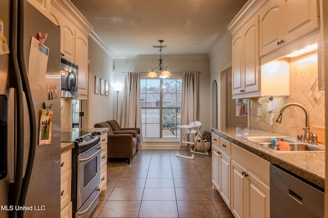 kitchen featuring sink, appliances with stainless steel finishes, backsplash, ornamental molding, and decorative light fixtures