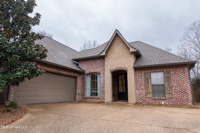 french provincial home featuring a garage