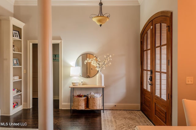 entryway with ornamental molding and dark hardwood / wood-style flooring