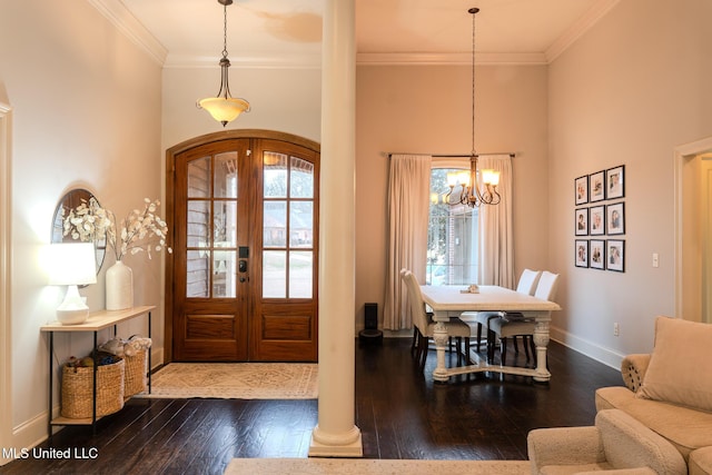 foyer entrance with ornamental molding, dark wood-type flooring, a healthy amount of sunlight, and french doors