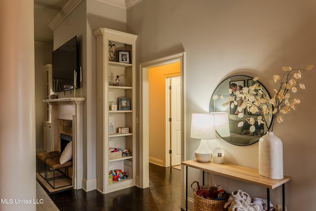 corridor with ornamental molding and dark hardwood / wood-style flooring