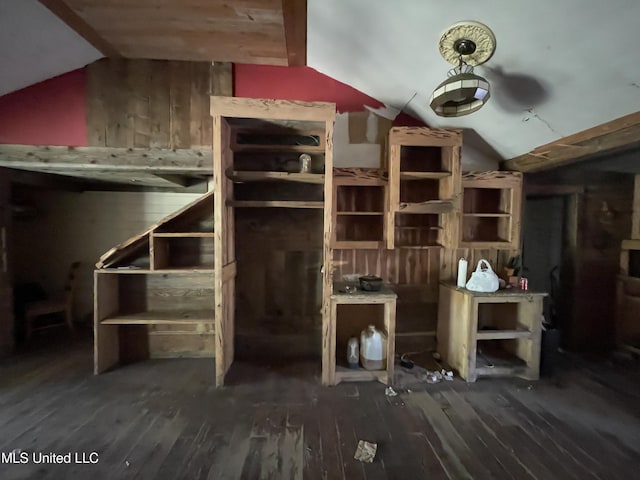 interior space featuring dark hardwood / wood-style flooring and vaulted ceiling