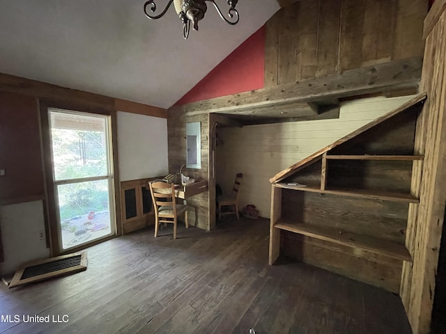 basement with dark wood-type flooring and a notable chandelier