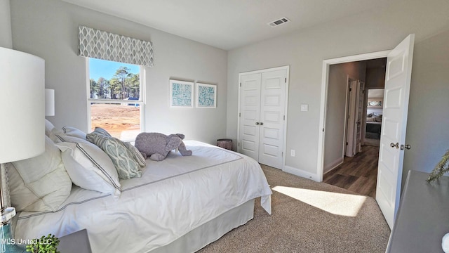 bedroom with dark carpet and a closet