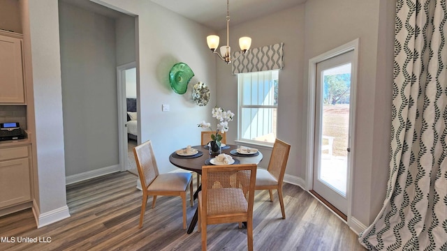 dining space featuring wood-type flooring and a chandelier