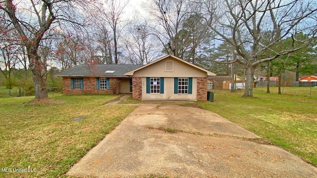 view of front of property featuring concrete driveway, brick siding, and a front lawn