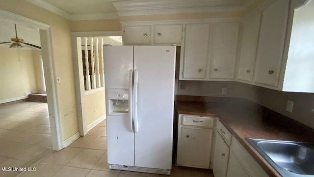 kitchen featuring ceiling fan, white cabinets, ornamental molding, white fridge with ice dispenser, and dark countertops