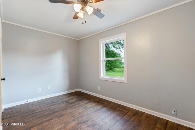 spare room featuring baseboards, ornamental molding, dark wood finished floors, and ceiling fan