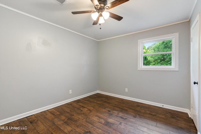 empty room with a ceiling fan, baseboards, dark wood-style floors, and crown molding