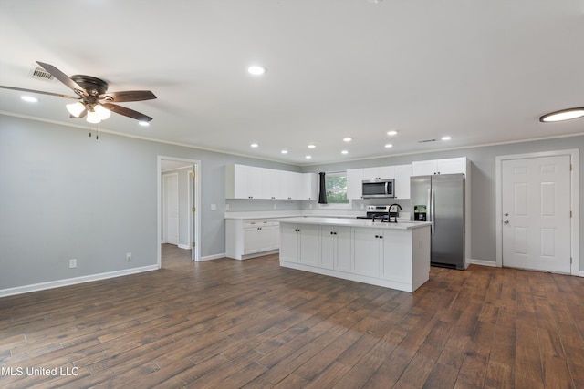 kitchen featuring appliances with stainless steel finishes, baseboards, dark wood finished floors, crown molding, and light countertops