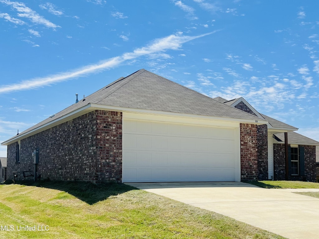 536 Fairway Ave, Byram, MS 39272 - view of front of house with brick siding, concrete driveway, a garage, and a front yard