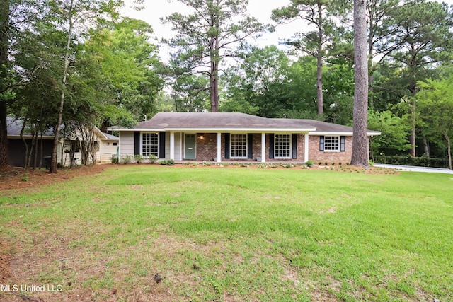 ranch-style house with a front yard and covered porch