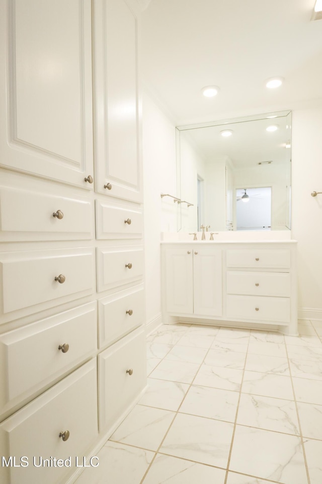 bathroom with recessed lighting, marble finish floor, vanity, and baseboards