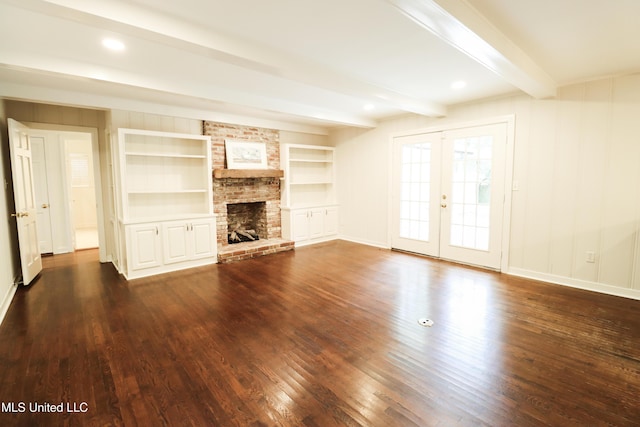 unfurnished living room featuring baseboards, a fireplace, dark wood-style flooring, french doors, and beamed ceiling