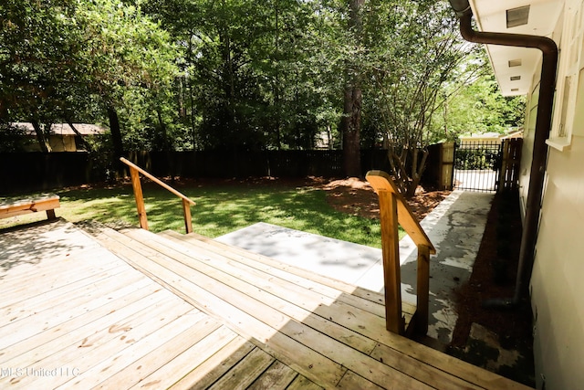 wooden terrace with a yard and a fenced backyard