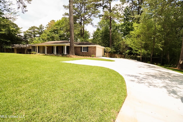 view of yard with driveway and a garage