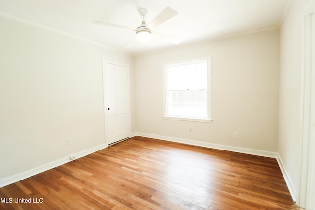 unfurnished room featuring light wood-style flooring, a ceiling fan, baseboards, and ornamental molding