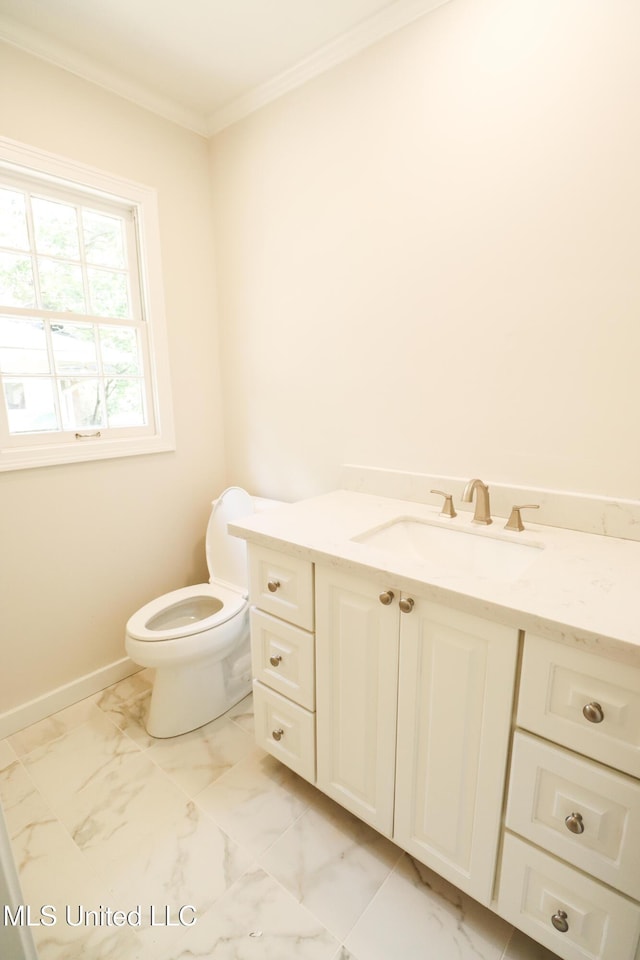 bathroom with vanity, baseboards, crown molding, toilet, and marble finish floor