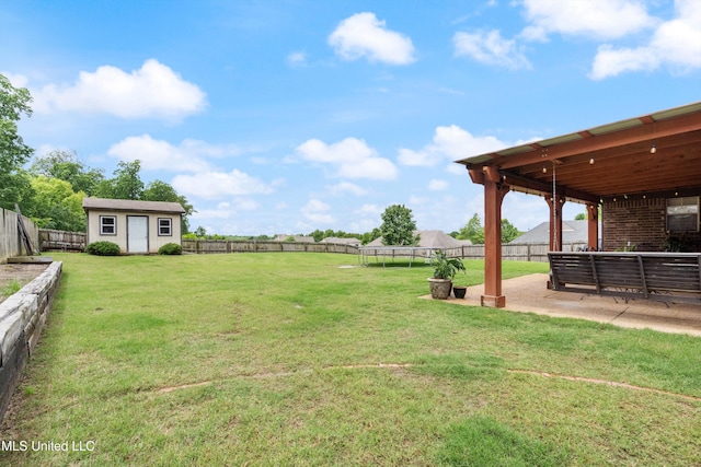 view of yard featuring an outbuilding and a patio