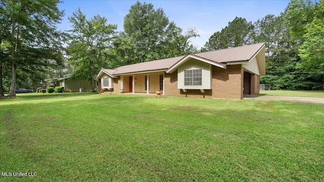 3222 Stage Rd, Morton, MS 39117 - single story home featuring concrete driveway, a front yard, covered porch, a metal roof, and brick siding