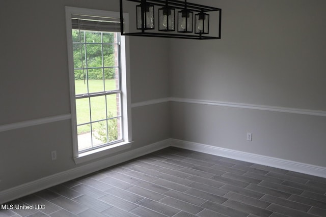 unfurnished dining area featuring baseboards