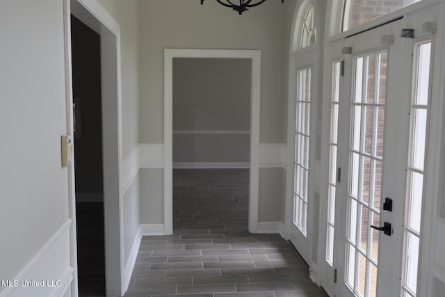 hall with wainscoting and dark wood-style floors