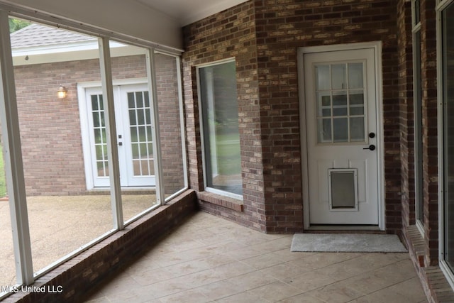 unfurnished sunroom with french doors
