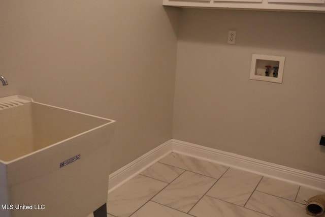 laundry room featuring baseboards, hookup for a washing machine, and light marble finish flooring