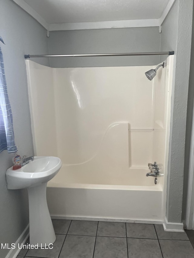 full bathroom featuring tile patterned flooring, shower / bath combination, and baseboards