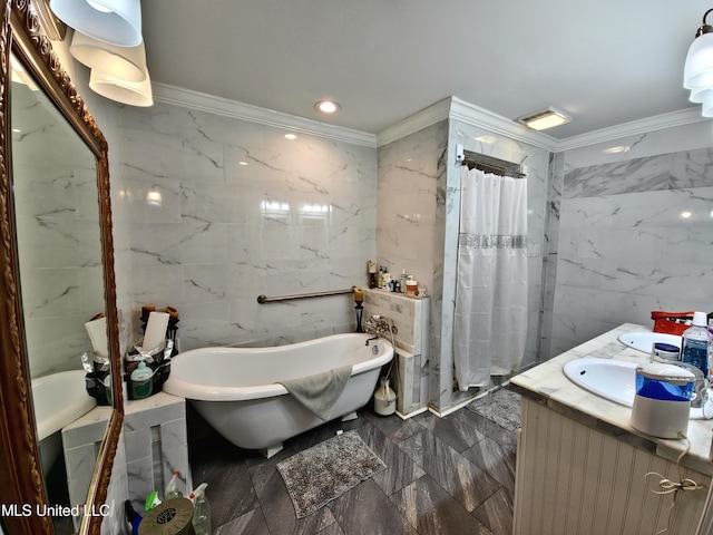 full bath with marble finish floor, ornamental molding, a freestanding tub, and tile walls