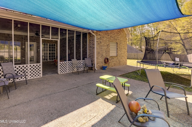 view of patio / terrace with ceiling fan and a trampoline