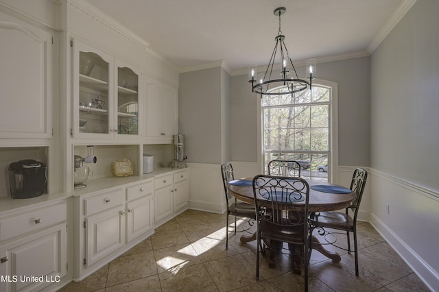 tiled dining area featuring a notable chandelier and ornamental molding