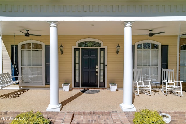 entrance to property featuring covered porch and ceiling fan