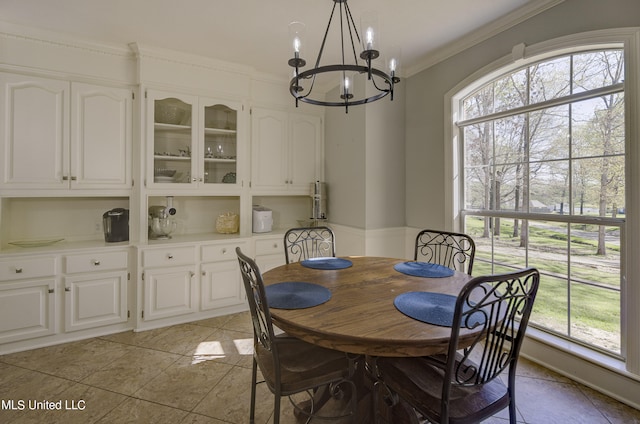 tiled dining room with crown molding, a notable chandelier, and a healthy amount of sunlight