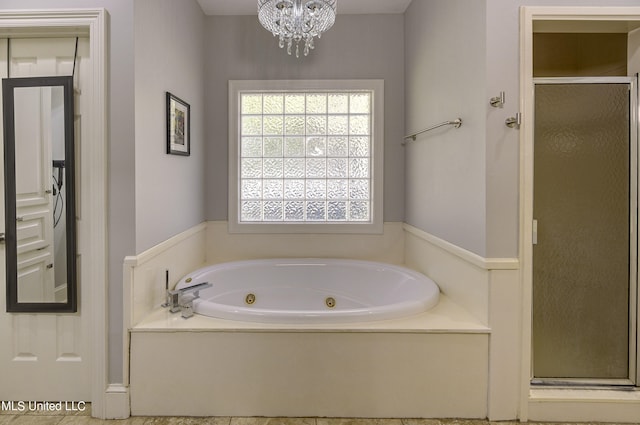 bathroom featuring tile patterned flooring, an inviting chandelier, and shower with separate bathtub