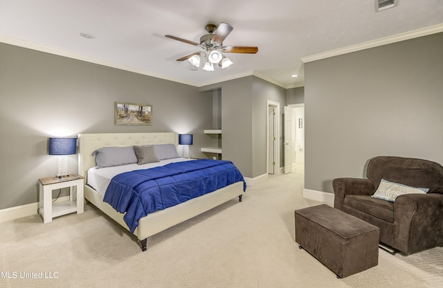 carpeted bedroom featuring ceiling fan, crown molding, and ensuite bath