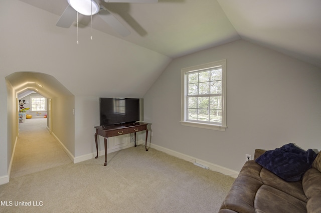 additional living space featuring vaulted ceiling, light carpet, and ceiling fan