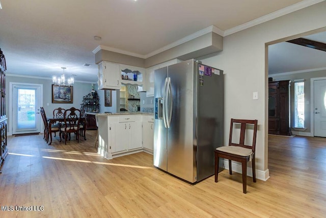 kitchen with a peninsula, light wood finished floors, white cabinetry, and stainless steel fridge with ice dispenser