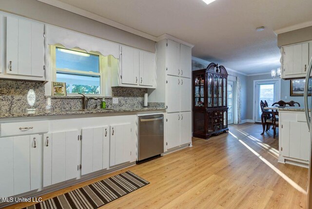 kitchen featuring a sink, light wood-style floors, crown molding, and dishwasher