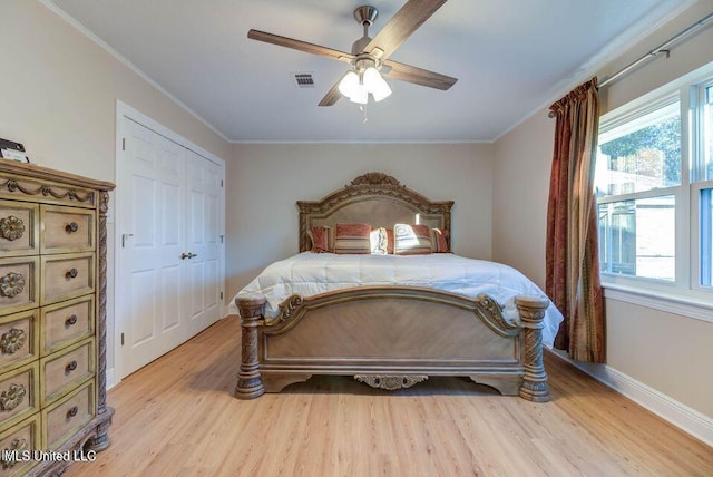 bedroom featuring light wood-type flooring, visible vents, and multiple windows