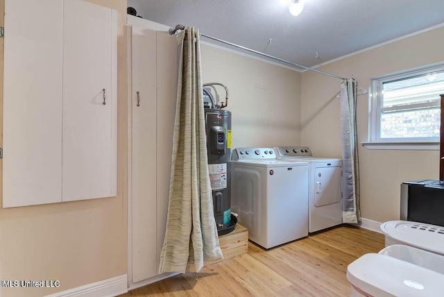 laundry room with laundry area, light wood-style flooring, ornamental molding, electric water heater, and washing machine and dryer