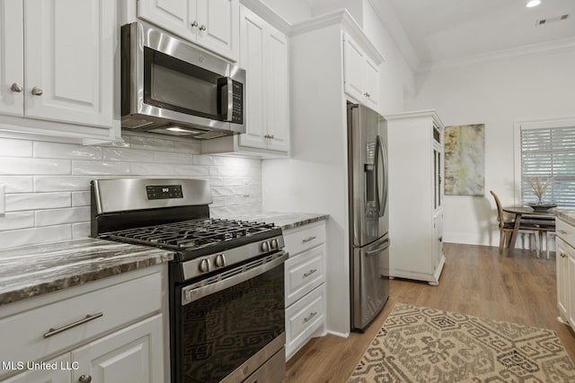 254 Buttonwood Ln, Canton, MS 39046 - kitchen with stainless steel appliances, crown molding, white cabinetry, light wood finished floors, and stone counters