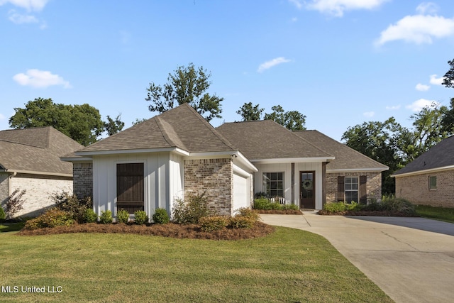 254 Buttonwood Ln, Canton, MS 39046 - view of front of house with a front lawn, concrete driveway, a garage, brick siding, and roof with shingles
