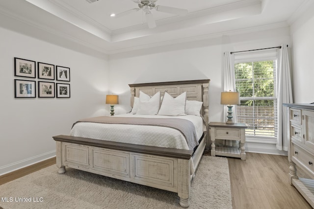 254 Buttonwood Ln, Canton, MS 39046 - bedroom featuring a tray ceiling, crown molding, light wood finished floors, and a ceiling fan
