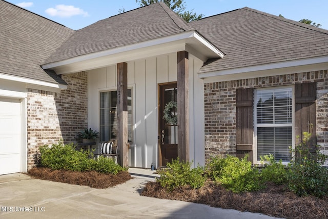 254 Buttonwood Ln, Canton, MS 39046 - property entrance featuring brick siding, a shingled roof, and a garage