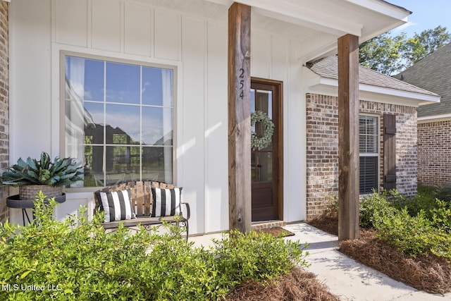 254 Buttonwood Ln, Canton, MS 39046 - view of exterior entry featuring board and batten siding and brick siding