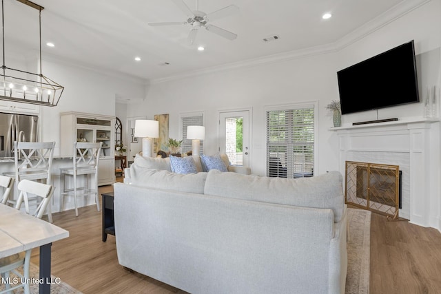 254 Buttonwood Ln, Canton, MS 39046 - living area featuring crown molding, a ceiling fan, light wood finished floors, recessed lighting, and a fireplace