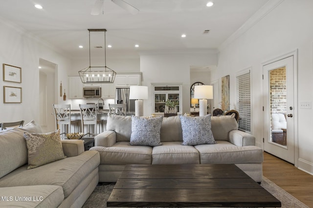 254 Buttonwood Ln, Canton, MS 39046 - living area with wood finished floors, a ceiling fan, ornamental molding, and recessed lighting
